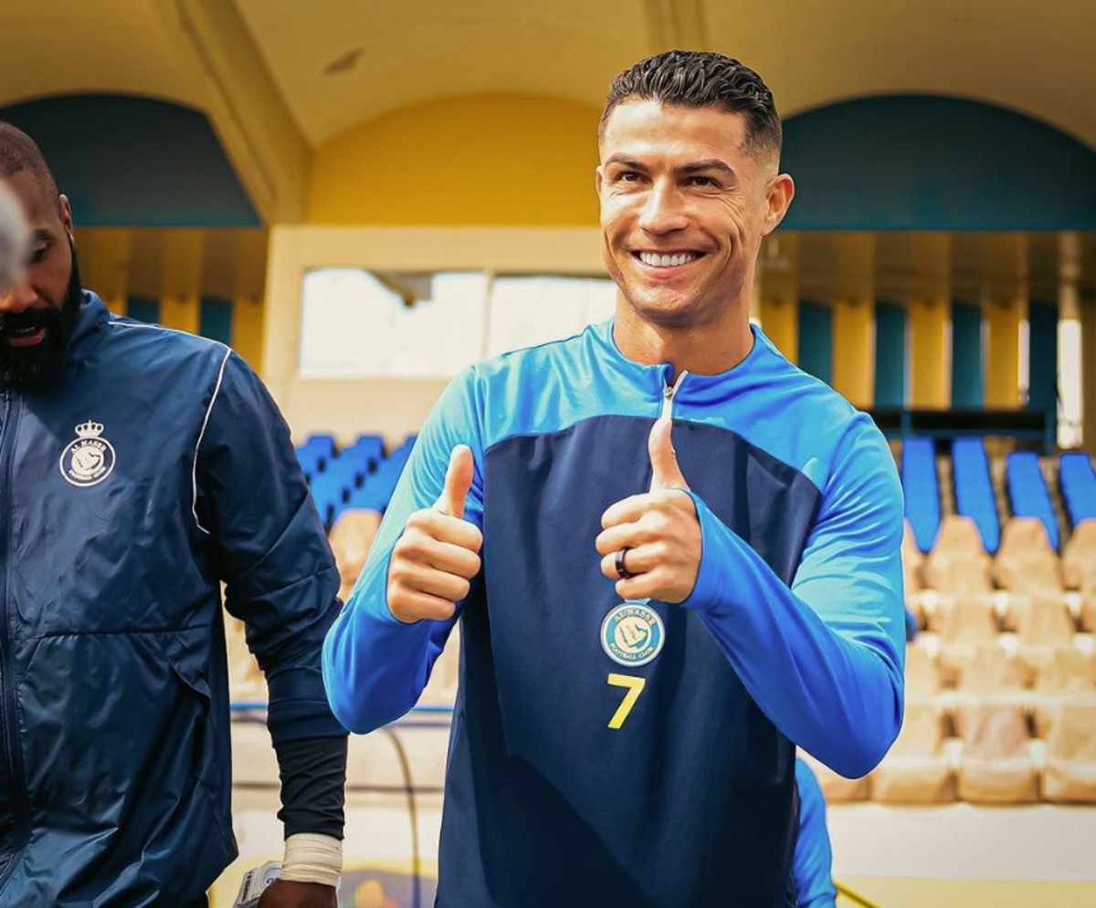 Cristiano Ronaldo pictured giving a double thumbs up gesture to the camera while posing for a photograph during an Al Nassr training session on his 39th birthday in February 2024